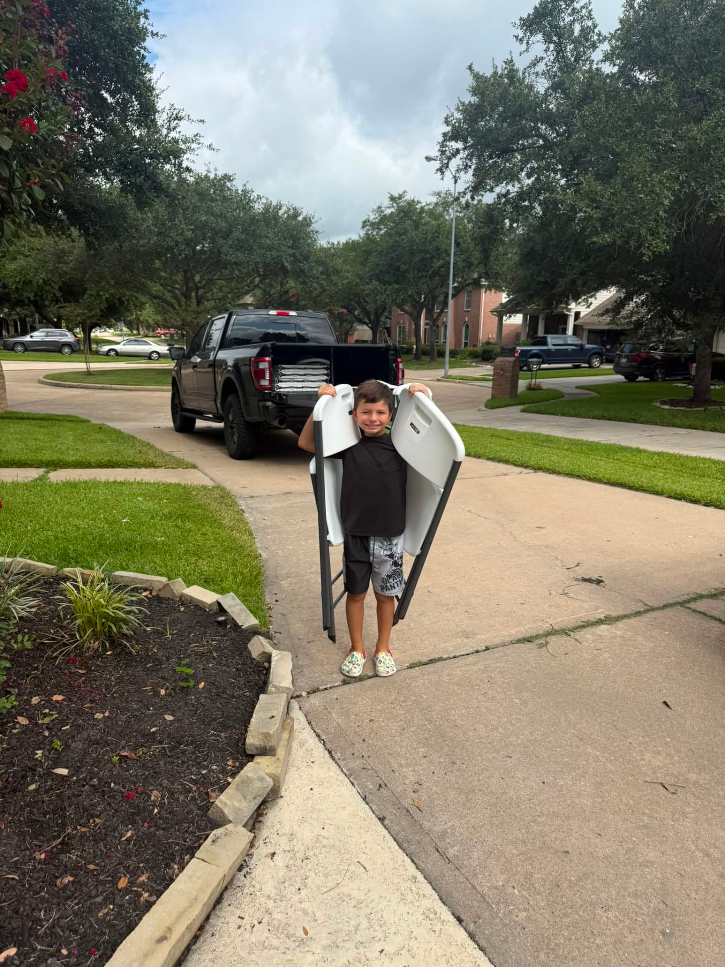 Family team delivering clean folding chair rentals for a party in Spring, Texas